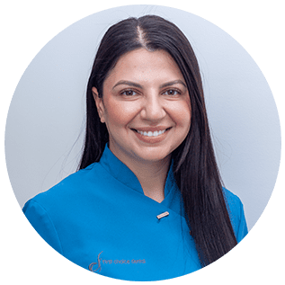 Mikaela, Dental Assistant at First Choice Dental, smiling warmly in her scrubs, bringing professionalism and compassion to patient care.